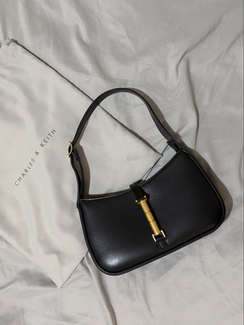 Charles and Keith Cesia Black Shoulder Bag (Category: Shoulder Bags) located in Quezon City. Submitted by a_closet04 (Listing ID 1460143982, Image 1). Description: - Brand: Charles & Keith - Color: Black - Feature: Gold buckle detail on the front - Closure: Zipper - Includes: Dust bag - Ideal for: Everyday use - my most favorite bag ever!!! RFS: investing in real leather bags 🤍.