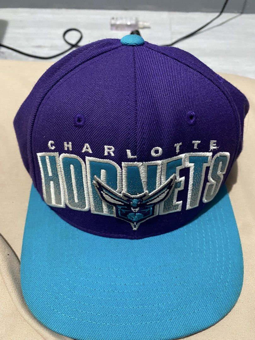 Charlotte Hornets two tone snapback hat (Category: Caps & Hats) located in Manila. Submitted by khielcalvin (Listing ID 1460226431, Image 1). Description: - Brand: Mitchell & Ness - Team: Charlotte Hornets - Style: Two-tone snapback hat - Colors: Purple crown, Teal brim - Features: Embroidered team logo and name on front Need new strap Offer Offer.