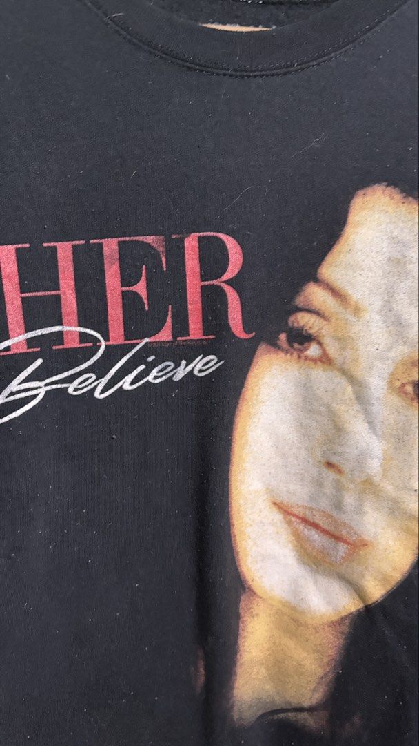 Cher Believe Graphic Sweatshirt Bravado MD (Category: Longsleeves) located in Baguio. Submitted by iconicsmeti (Listing ID 1460161606, Image 3). Description: - Black sweatshirt featuring Cher graphic and 'Believe' text - Brand: Bravado - Size: MD - Material: Cotton-Polyester blend - Ideal for Cher fans - Comfortable for casual wear - lints and hairline crack.