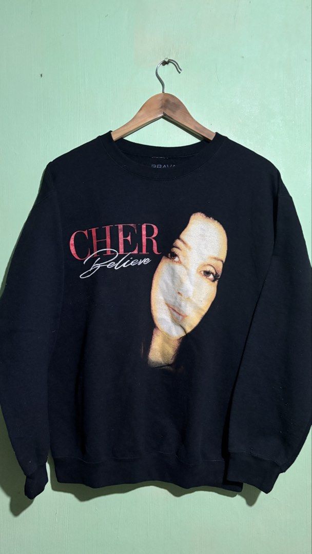 Cher Believe Graphic Sweatshirt Bravado MD (Category: Longsleeves) located in Baguio. Submitted by iconicsmeti (Listing ID 1460161606, Image 1). Description: - Black sweatshirt featuring Cher graphic and 'Believe' text - Brand: Bravado - Size: MD - Material: Cotton-Polyester blend - Ideal for Cher fans - Comfortable for casual wear - lints and hairline crack.