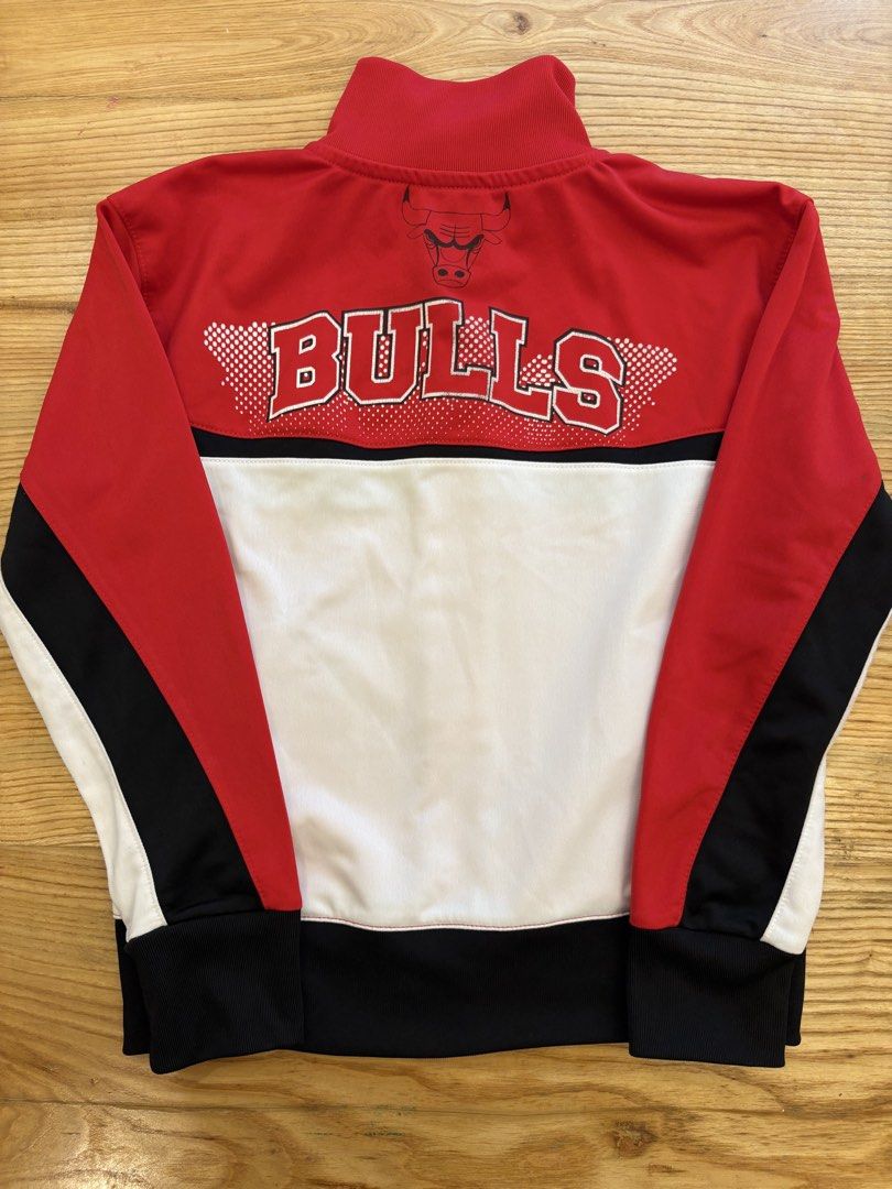 Chicago Bulls Track Jacket Red Black White (Category: Babies & Kids Fashion) located in Paranaque City. Submitted by yanionlineshopping (Listing ID 1460237150, Image 2). Description: - Red Chicago Bulls track jacket - Official Bulls logo on front and back - Black and white sleeve and side accents - Full zip closure - Ribbed collar, cuffs, and hem - Ideal for any Chicago Bulls enthusiast.