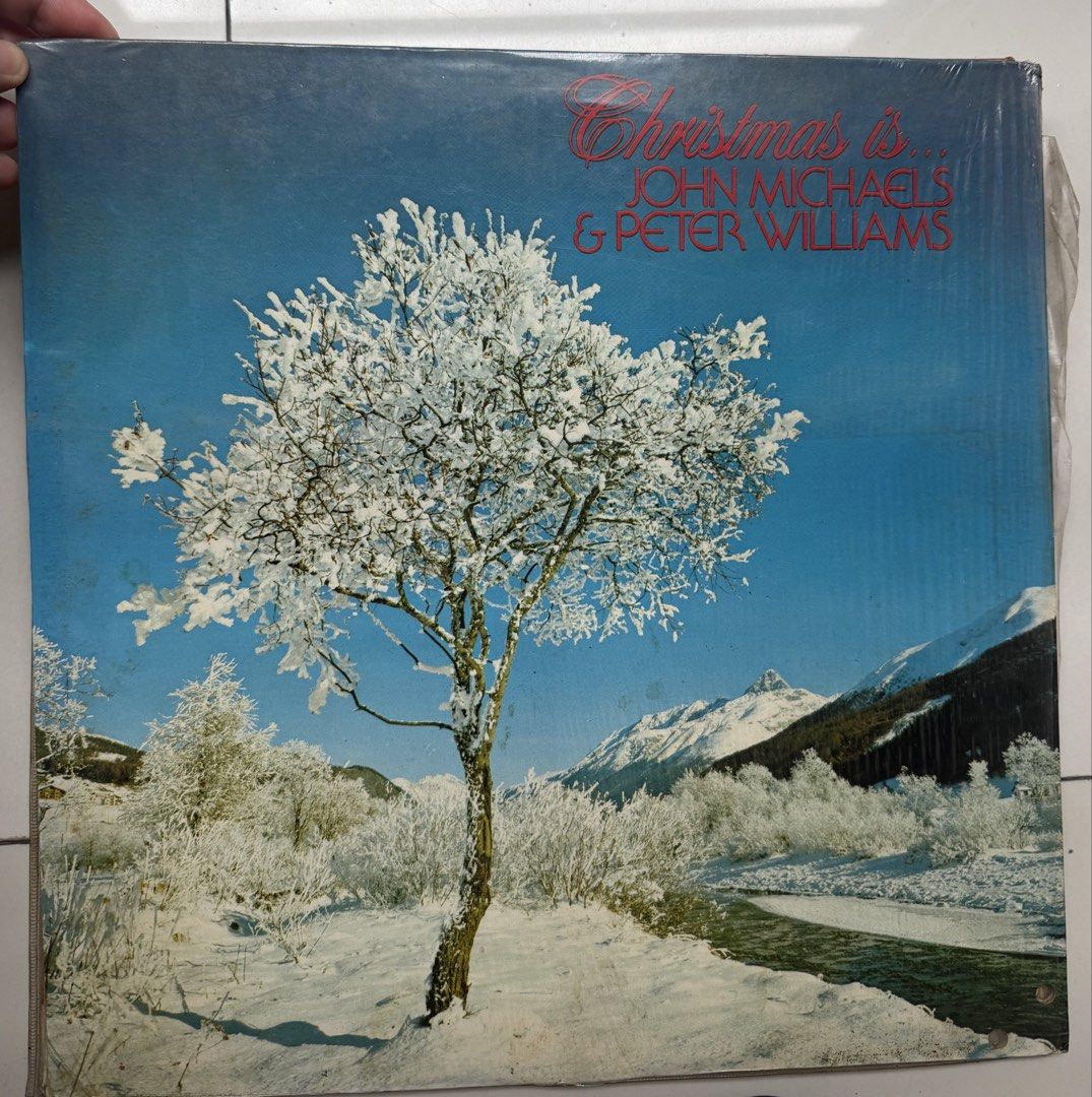 Christmas Is... John Michaels & Peter Williams Vinyl Record (Category: Vinyls) located in Manila. Submitted by eithne128 (Listing ID 1460156677, Image 1). Description: - Classic Christmas vinyl record featuring John Michaels and Peter Williams. - Beautiful cover art: snowy landscape with a tree and mountains. - A must-have for your holiday music collection. - Ideal for creating a cozy winter atmosphere..