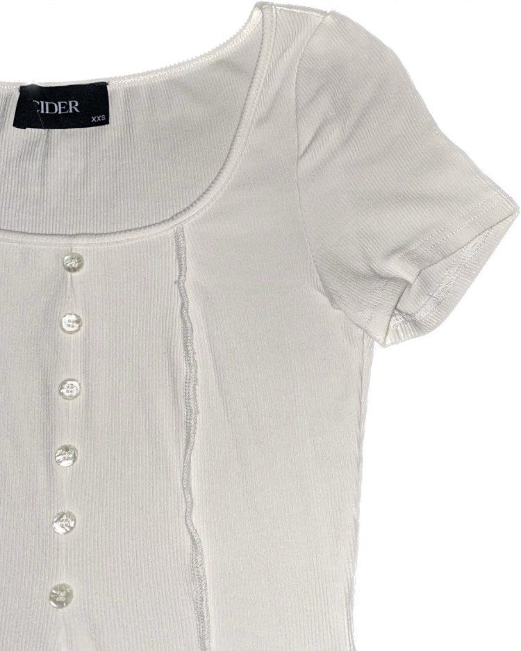 CIDER white ribbed button-up short sleeve crop top (Category: Blouses) located in Quezon City. Submitted by julesoutfitters (Listing ID 1460190503, Image 2). Description: - ribbed material with button-up front - scoop neckline - slit in the abdomen area for a cute cropped look - fitted tshirt - payment through bank transfer - don’t hesitate to send me a message if you have any questions or want more pictures ! 🧑🏻‍🩰.