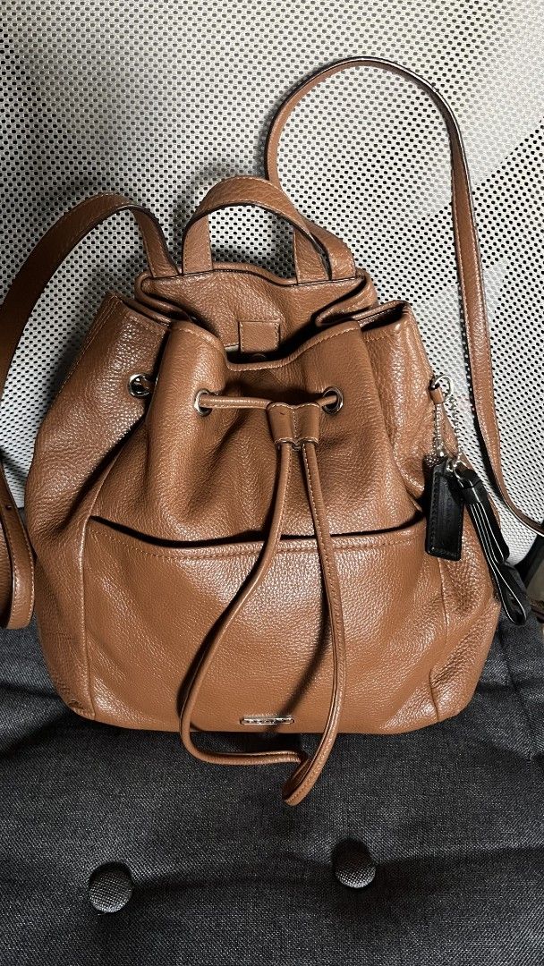 Coach Brown Leather Drawstring Backpack (Category: Backpacks) located in Taguig. Submitted by aguilacrisann (Listing ID 1460303315, Image 1). Description: - Brand: Coach - Material: Brown pebbled leather - Closure: Drawstring - Features: Top handle, adjustable shoulder straps, front pocket, interior pockets - Condition: Great for everyday use or travel - Includes: Coach leather tag no issue, no bakbak, soft leather , kasya foldable payong and ipa