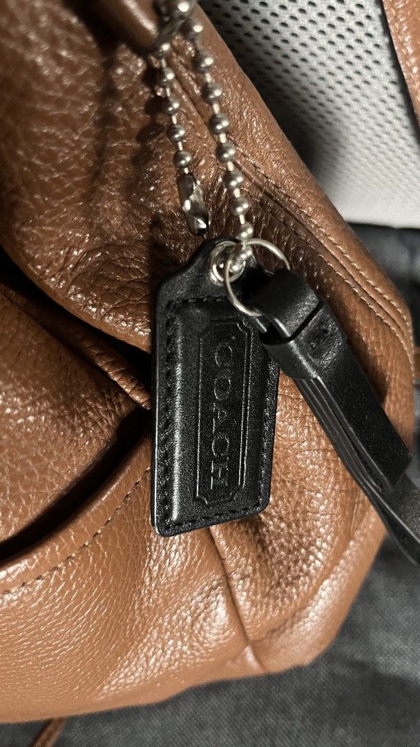 Coach Brown Leather Drawstring Backpack (Category: Backpacks) located in Taguig. Submitted by aguilacrisann (Listing ID 1460303315, Image 2). Description: - Brand: Coach - Material: Brown pebbled leather - Closure: Drawstring - Features: Top handle, adjustable shoulder straps, front pocket, interior pockets - Condition: Great for everyday use or travel - Includes: Coach leather tag no issue, no bakbak, soft leather , kasya foldable payong and ipa