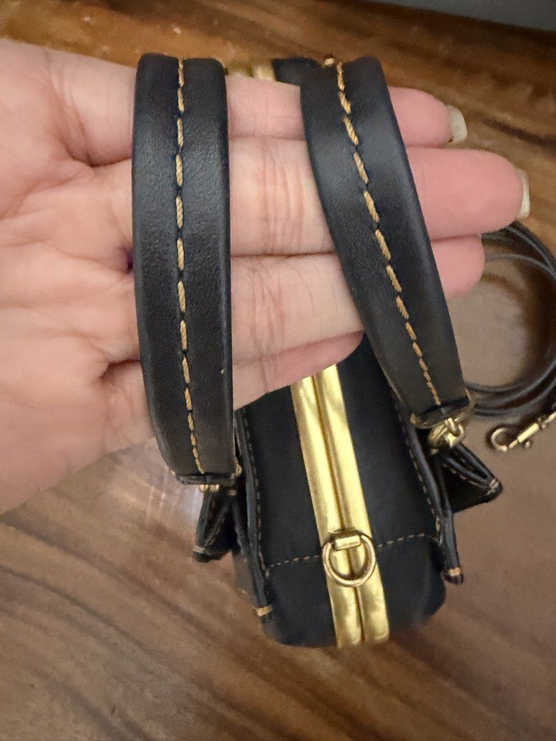 Coach Kisslock Dreamer Mini (Category: Luxury Bags & Wallets) located in Makati City. Submitted by petite_preloved2 (Listing ID 1460134739, Image 2). Description: Authentic Coach All hang tags are present Flawless rubber lining Minimal fading on the hardware but still very gold Clean interior With discoloration on both sides of the monogram leather..