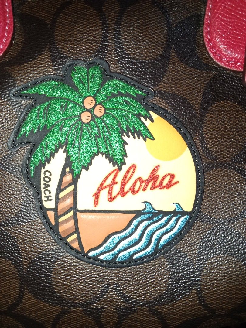 Coach Monogram "Aloha" Tropical Print Satchel Bag (Category: Luxury Bags & Wallets) located in Nagcarlan. Submitted by irishcasta73122 (Listing ID 1460144364, Image 2). Description: from Japan slightly negotiable issue creed - Authentic Coach satchel bag - Classic monogram print - "Aloha" tropical patch on the front - Bright pink leather trim and handles - Vibrant pink interior - Detachable shoulder strap included - Ideal for a pop of color and v
