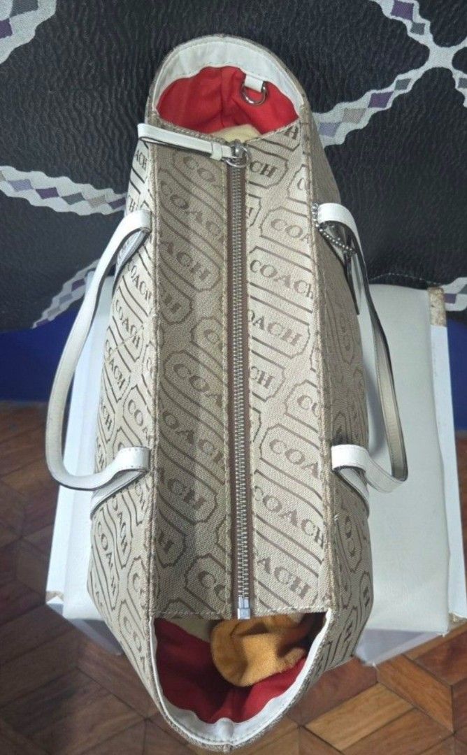 OG Coach Monogram Canvas Tote (Category: Luxury Bags & Wallets) located in Manila. Submitted by affordabags_cd (Listing ID 1460225829, Image 3). Description: - Classic Coach tote bag - Beige canvas with all-over Coach logo pattern - White leather trim and handles - Secure zipper closure - Eye-catching red interior lining - Interior model number: H0849-F12253 - Ideal everyday bag.