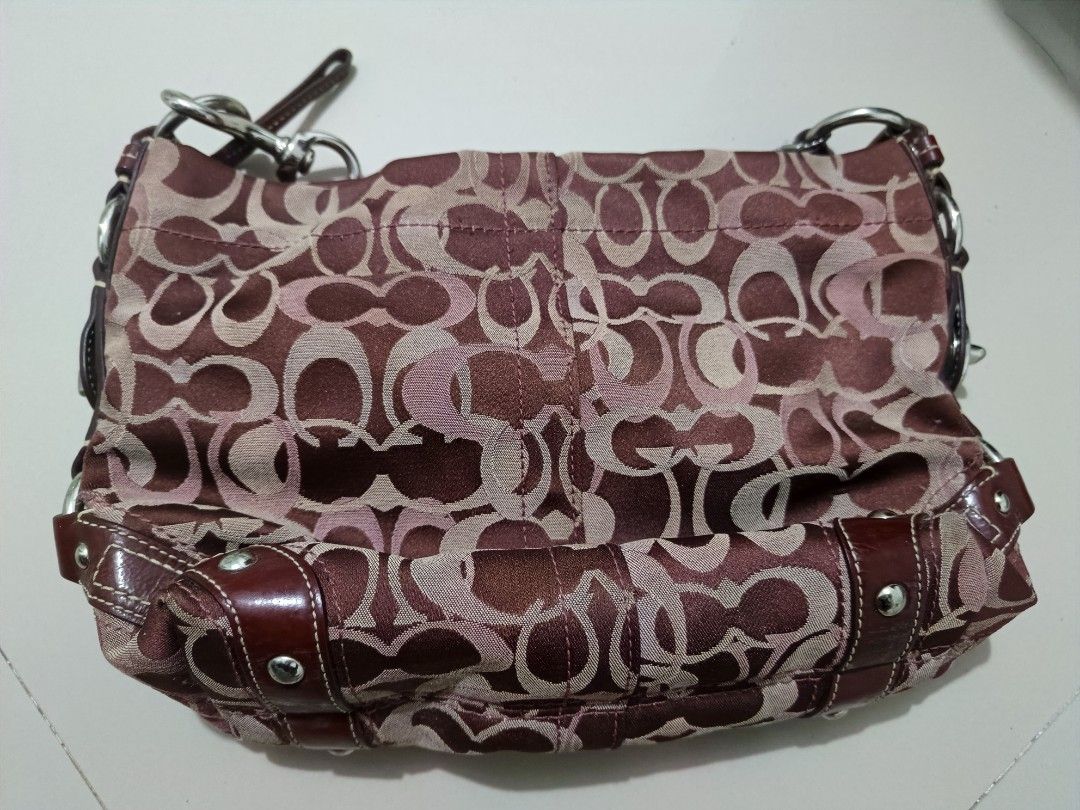 Coach Monogram Shoulder Bag (Category: Luxury Bags & Wallets) located in Angeles City. Submitted by gian1994 (Listing ID 1460193956, Image 2). Description: - Coach monogram shoulder bag - Burgundy and tan signature pattern - Leather trim and handles - Silver hardware - Interior zip and slip pockets - Clean interior - Great everyday bag.