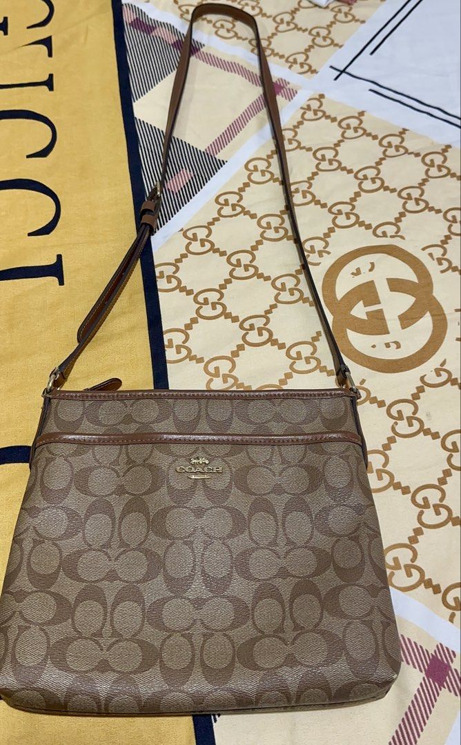 Coach Signature Monogram Crossbody Bag (Category: Luxury Bags & Wallets) located in Manila. Submitted by rachael_23 (Listing ID 1460174268, Image 1). Description: - Classic Coach crossbody bag - Signature all-over monogram pattern - Brown leather trim and strap - Secure zipper closure - Ideal for everyday use - Fits essentials easily Binili ko sa US this is my personal na gamit. Pre loved .