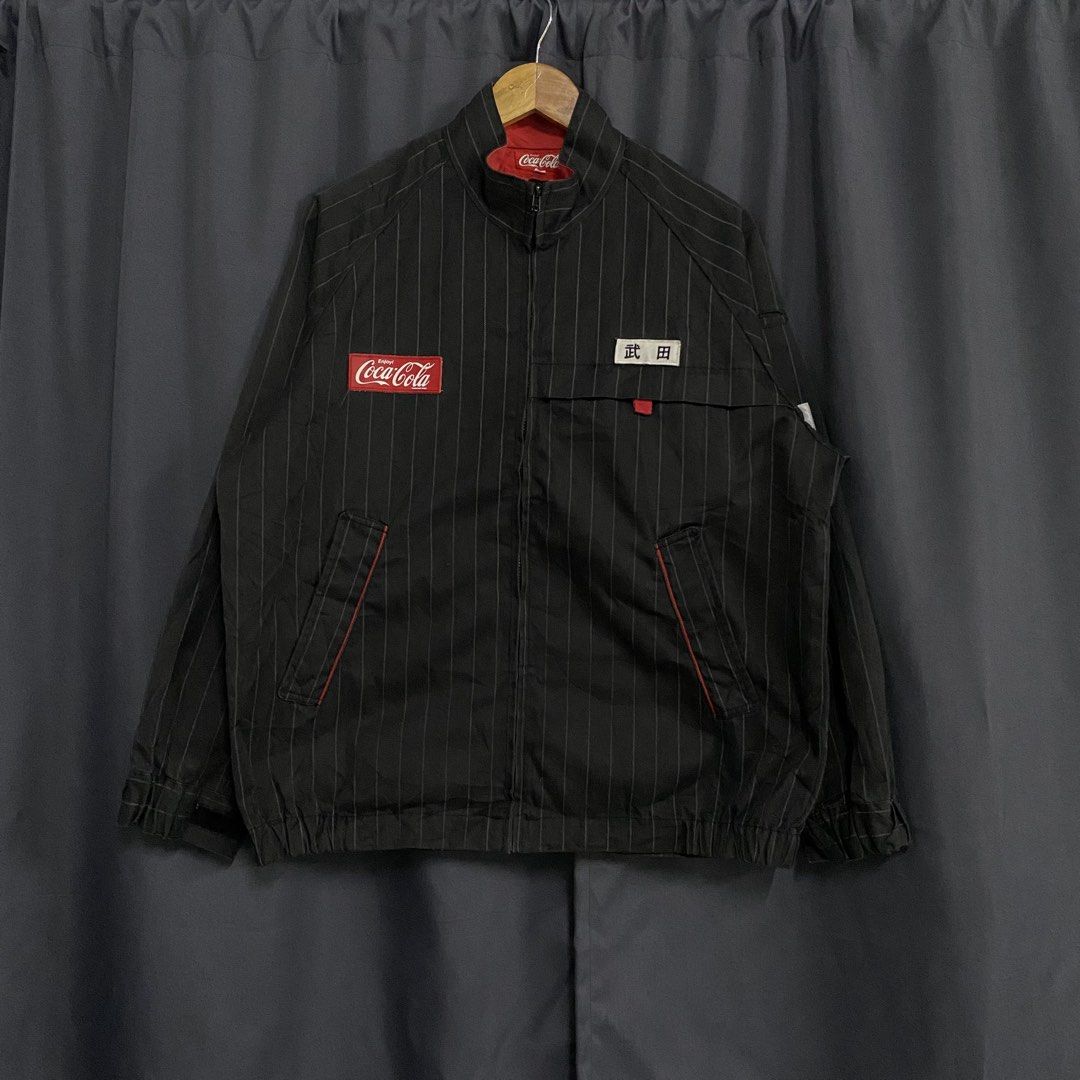 Coca-Cola Pinstripe Jacket with Japanese Text (Category: Coats, Jackets and Outerwear) located in Santa Maria. Submitted by saintarchive316 (Listing ID 1460252327, Image 1). Description: - Stylish black Coca-Cola jacket - Features white pinstripes - Classic Coca-Cola logo on front and back - Includes unique Japanese text patches - Red collar and trim details for a pop of color - Convenient zip-up front - A must-have for any Coca-Cola enthusiast!.