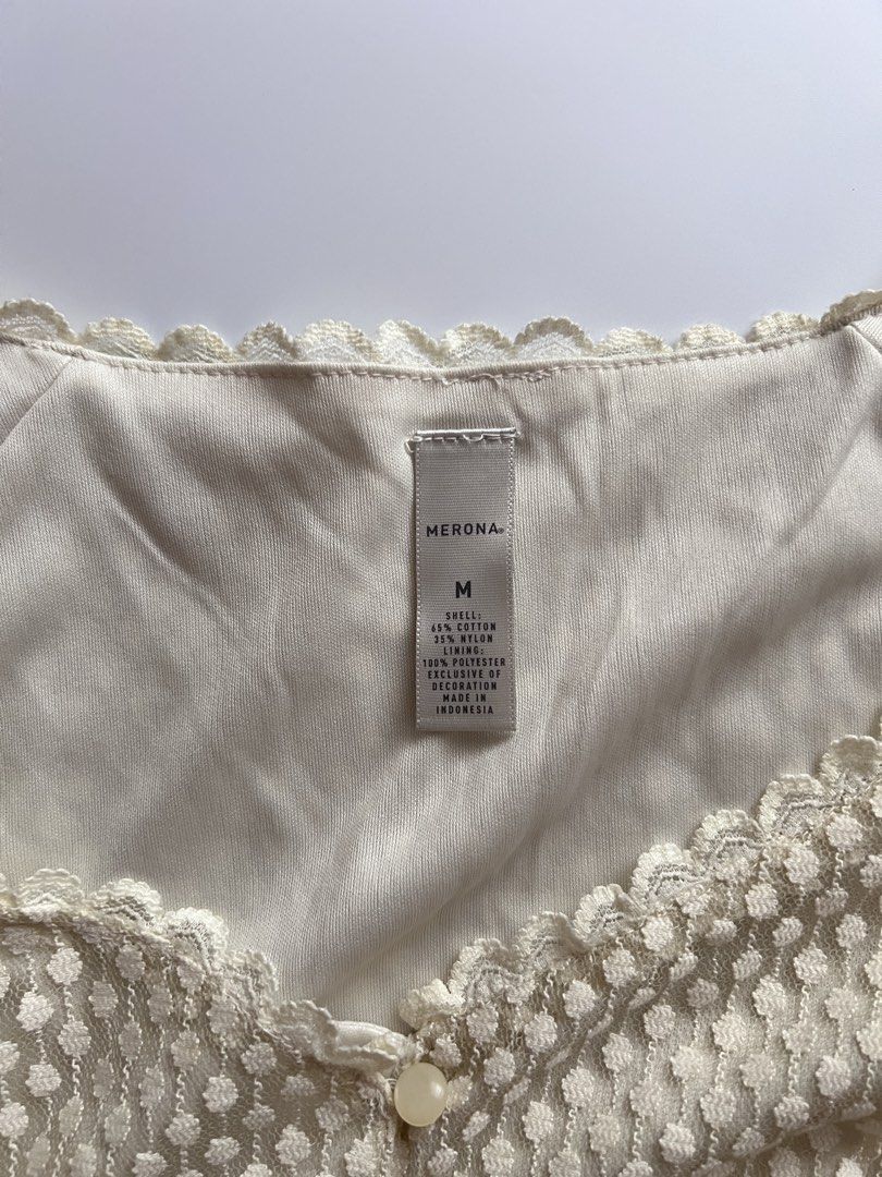 cream white babydoll top (Category: Sleeveless) located in Dasmarinas. Submitted by pinex (Listing ID 1460160194, Image 3). Description: - cream white lacy babydoll top - some discolorations due to storage - tag and extra button still intact - measurements laid flat: straps to hem: 25 in pit to pit: 16 in.