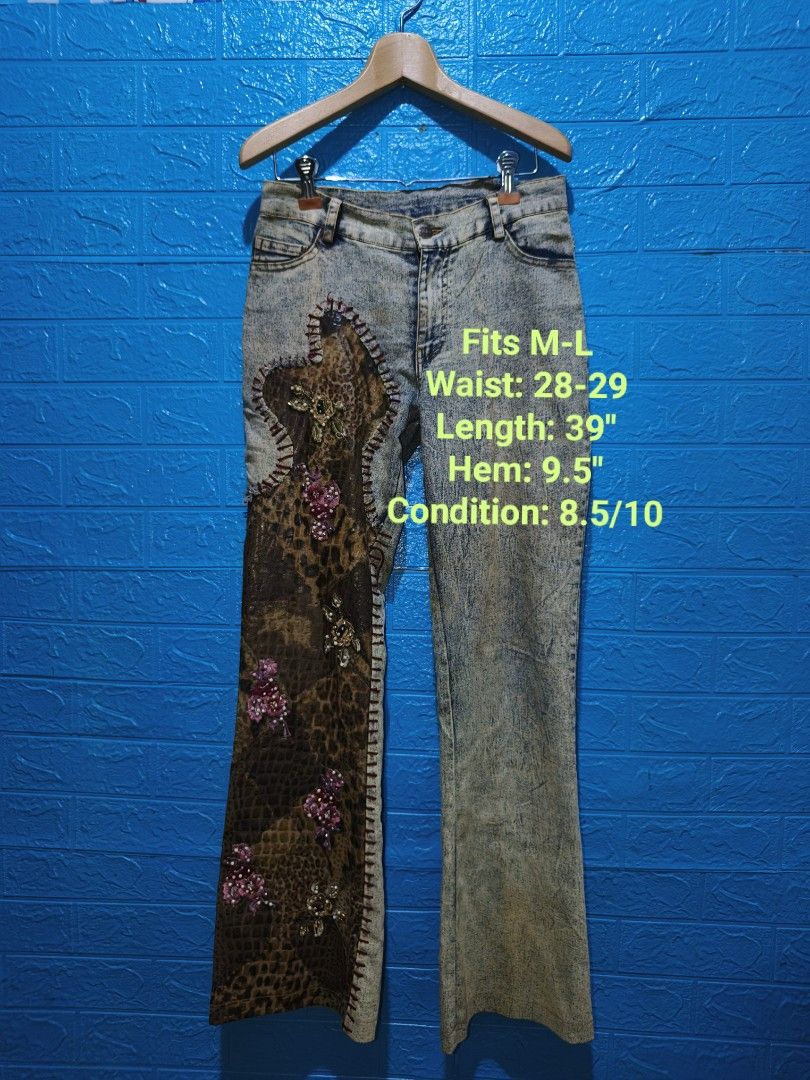 Customized Fairycore Denim Jeans (Category: Jeans) located in Davao. Submitted by vndrgd (Listing ID 1460115515, Image 1). Description: - Unique customized denim jeans - Bold leopard print panel on one leg - Intricate floral embroidery and beadwork - Washed-out acid wash effect - Fits waist sizes 28-29 inches - Total length: 39 inches - Hem measurement: 9.5 inches - A true statement piece!.