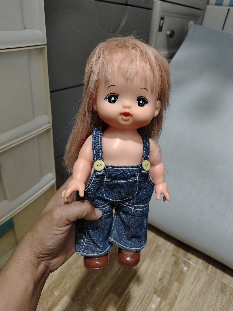 Cute Doll with Overalls and Red Hat (Category: Kids Toys) located in Makati City. Submitted by abegailbrezuela (Listing ID 1460159891, Image 1). Description: - Doll with long, light brown hair - Adorable denim overalls with yellow buttons - Comes with a cute red hat featuring a flower detail - Includes brown shoes - Ideal for both playtime and decorative display.