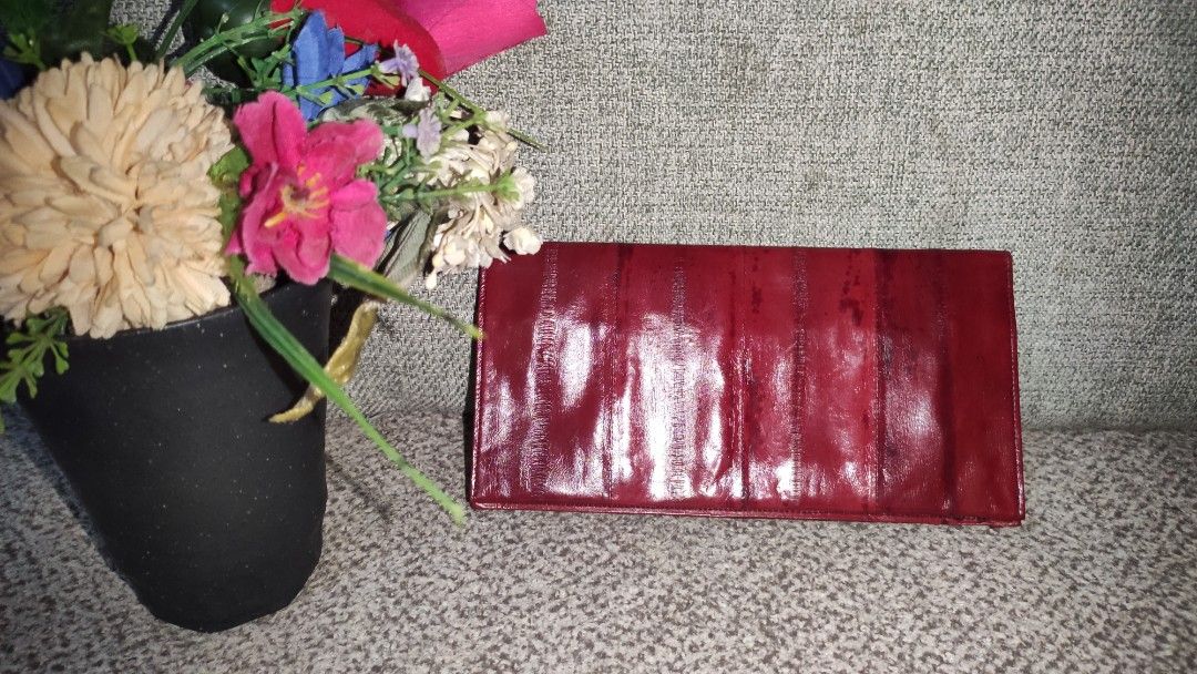 Dark Brick Red Eel Skin Envelope Wallet Checkbook Holder (Category: Wallets & Card holders) located in Imus. Submitted by ryanneakiko (Listing ID 1460159642, Image 2). Description: - Genuine eel skin in a rich dark brick red. - Stylish envelope design, also fits a checkbook. - Features multiple card slots for easy organization. - Includes a secure zippered compartment for coins or small items. - Unique, textured material adds a touch of luxury. -