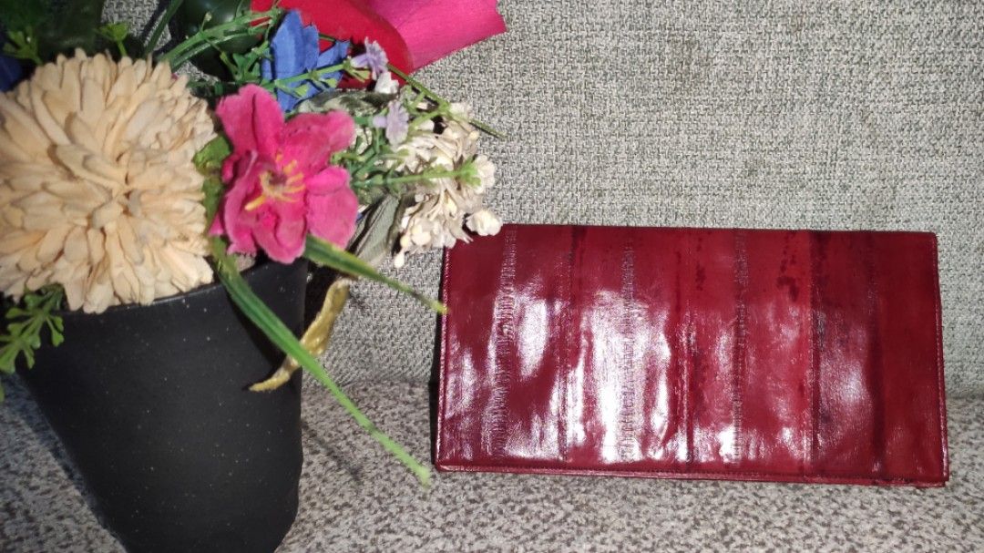 Dark Brick Red Eel Skin Envelope Wallet Checkbook Holder (Category: Wallets & Card holders) located in Imus. Submitted by ryanneakiko (Listing ID 1460159642, Image 1). Description: - Genuine eel skin in a rich dark brick red. - Stylish envelope design, also fits a checkbook. - Features multiple card slots for easy organization. - Includes a secure zippered compartment for coins or small items. - Unique, textured material adds a touch of luxury. -