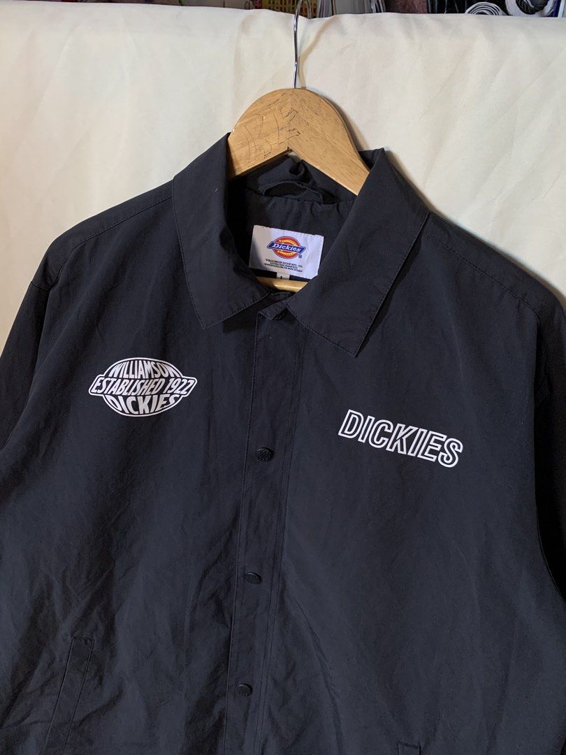 Dickies Black Coach Jacket "Established 1922" Logo Size L (Category: Coats, Jackets and Outerwear) located in Davao. Submitted by cheineebau09680 (Listing ID 1460209261, Image 2). Description: - Black Dickies Coach Jacket - Size: Large (L) - Features 'Williamson-Dickie' 1922 logo on left chest and 'Dickies' text on right - Button-up front with a classic collar - Material: Cotton and Polyester blend - Ideal for everyday casual wear.