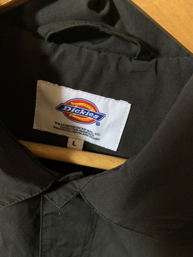 Dickies Black Coach Jacket "Established 1922" Logo Size L (Category: Coats, Jackets and Outerwear) located in Davao. Submitted by cheineebau09680 (Listing ID 1460209261, Image 3). Description: - Black Dickies Coach Jacket - Size: Large (L) - Features 'Williamson-Dickie' 1922 logo on left chest and 'Dickies' text on right - Button-up front with a classic collar - Material: Cotton and Polyester blend - Ideal for everyday casual wear.
