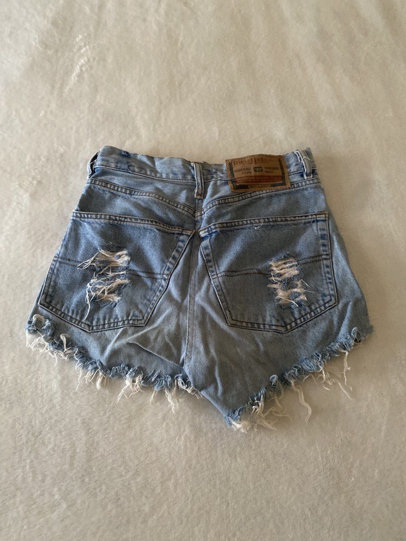 Diesel Distressed Denim Shorts Size 33 (Category: Shorts) located in Batangas. Submitted by v.ukay (Listing ID 1460132180, Image 3). Description: - Brand: Diesel - Style: Light wash denim shorts - Features: Distressed rips, frayed hem - Pockets: Classic five-pocket style - Closure: Zip fly - Size: 33 - Occasion: Casual wear.