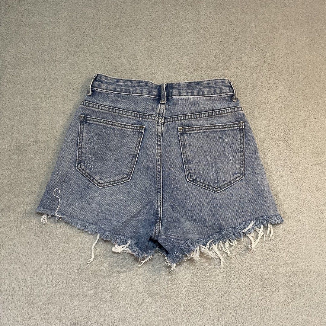 Distressed Denim Shorts with Frayed Hem (Category: Shorts) located in Taguig. Submitted by shopgrocer (Listing ID 1460159351, Image 2). Description: Distressed blue denim shorts with frayed hem and rips. High-waisted with button/zip closure and pockets. Perfect for casual outfits..