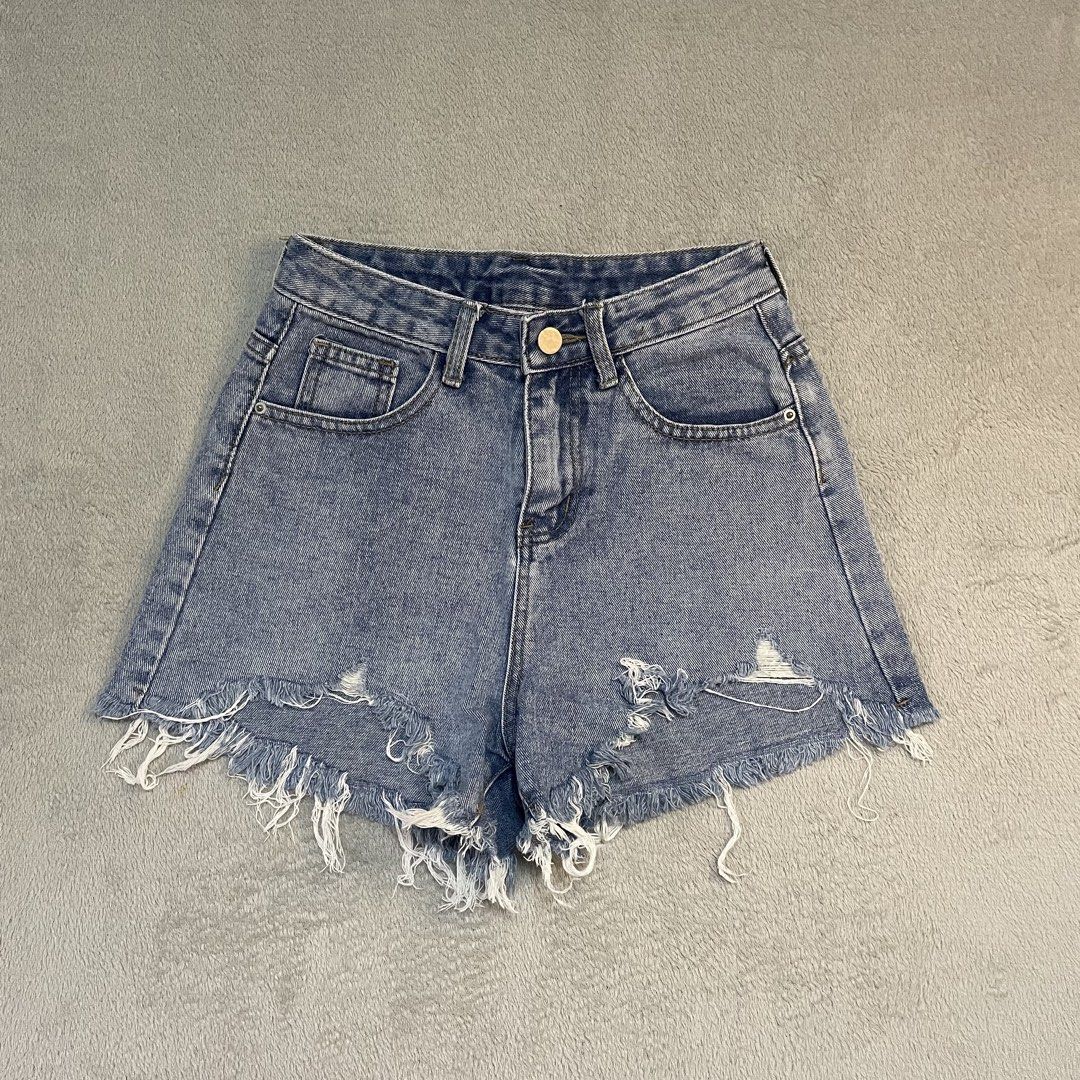 Distressed Denim Shorts with Frayed Hem (Category: Shorts) located in Taguig. Submitted by shopgrocer (Listing ID 1460159351, Image 1). Description: Distressed blue denim shorts with frayed hem and rips. High-waisted with button/zip closure and pockets. Perfect for casual outfits..