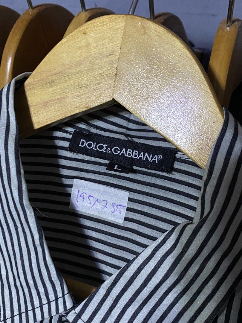 Dolce & Gabbana Striped Button-Up Shirt L (Category: Luxury Apparel) located in Santa Ana. Submitted by tunes_vtg (Listing ID 1460213700, Image 3). Description: - Dolce & Gabbana button-up shirt - Classic black and white vertical stripe pattern - Features D&G logo on the buttons - Size: Large (L) - Perfect for both casual and formal styling - Excellent condition - No issues - Dimes:L28.5xW19.5 ₱500+Sf.