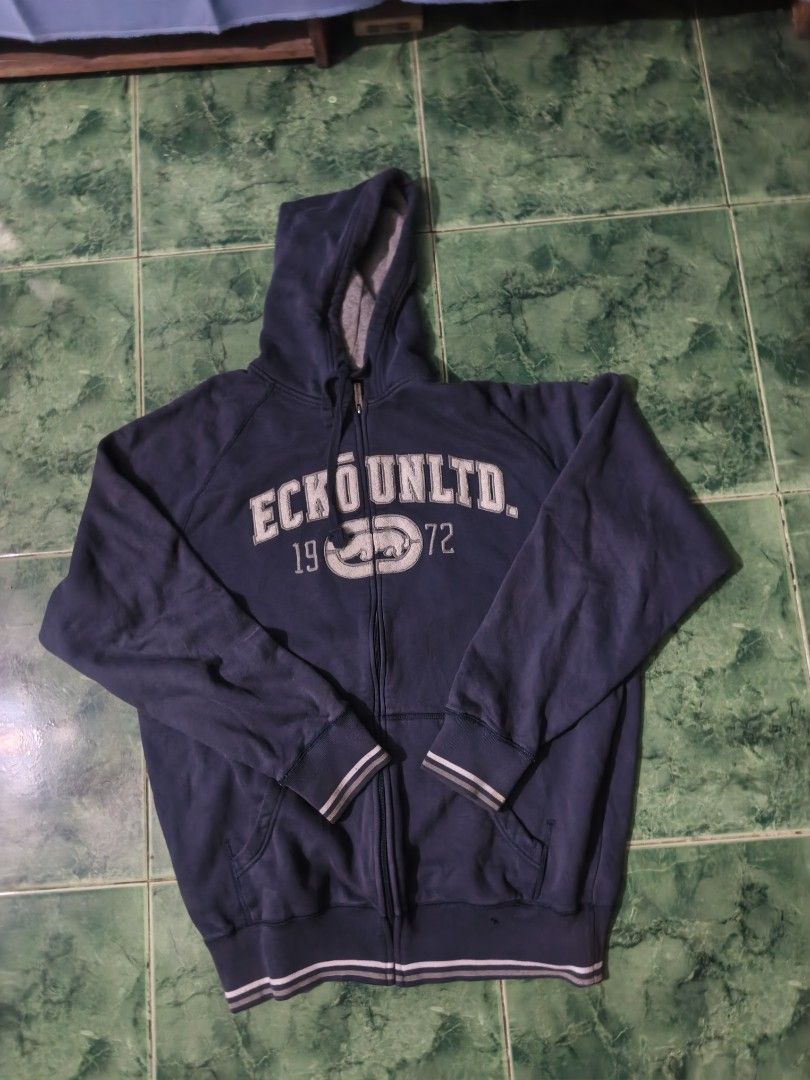 Ecko Unltd. Zip-Up Hoodie (Category: Hoodies) located in Bacoor. Submitted by davealvare39194 (Listing ID 1460223547, Image 1). Description: - Navy blue Ecko Unltd. zip-up hoodie - Features Ecko logo and '1972' on the front - Ribbed cuffs and hem with stripe detail - Two front pockets - Ideal for casual wear.