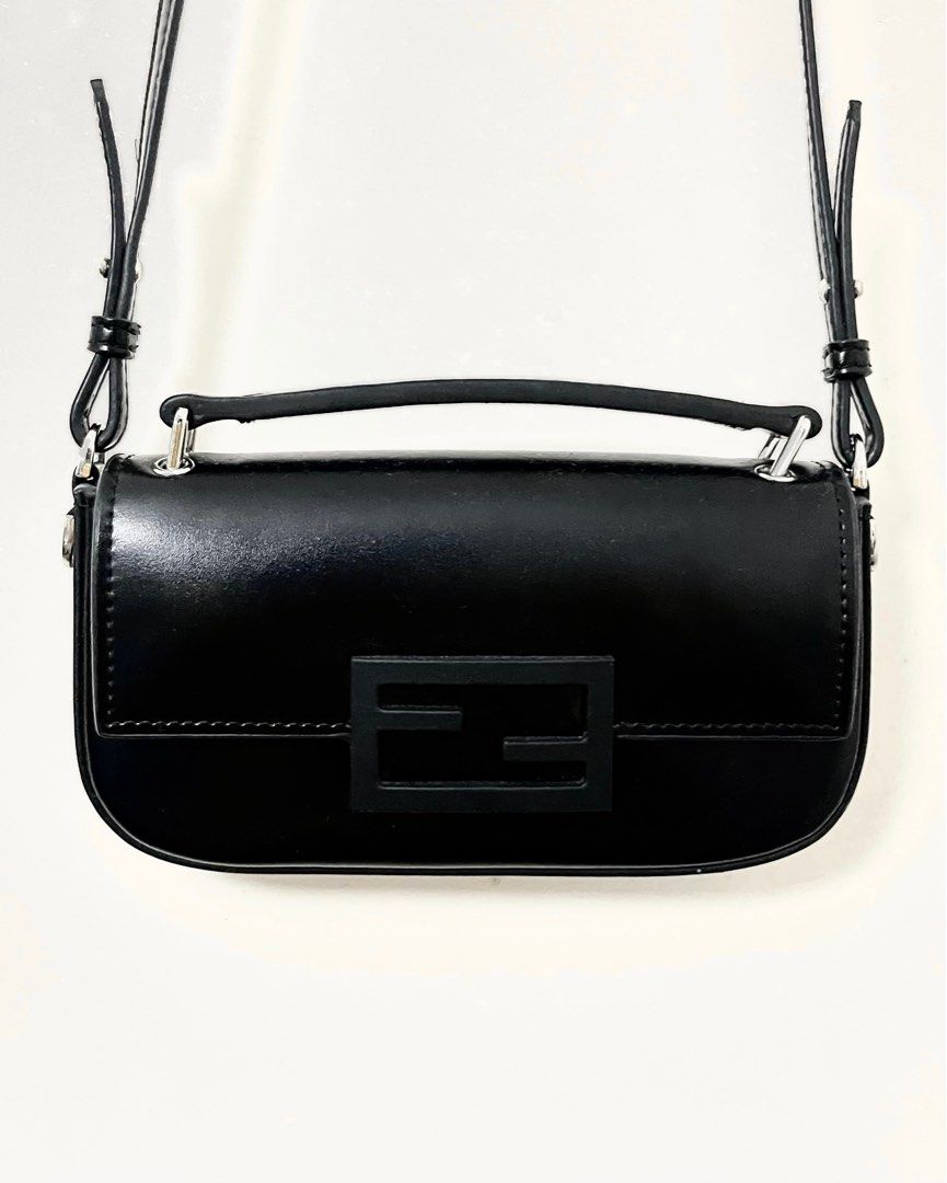 Fendi Baguette Phone Pouch (Category: Luxury Bags & Wallets) located in Manila. Submitted by kdclutter (Listing ID 1460241991, Image 1). Description: Fendi Baguette Phone Pouch - Color Black🖤 - Silver Hardware - With Tag/Etiquette - Adjustable/Detachable Sling - Preloved with Normal Signs of Use - No Major Flaws- Very Good Overall Condition DM for More Deets!!!.