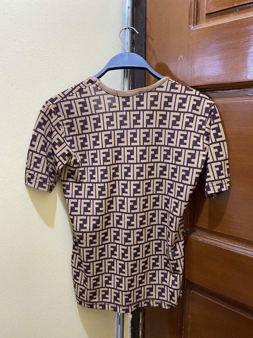 Fendi FF Monogram T-Shirt (Category: Luxury Apparel) located in Manila. Submitted by haveago0dthrift (Listing ID 1460151442, Image 2). Description: - Authentic Fendi FF monogram t-shirt - Classic brown and beige colorway - Short sleeves and round neckline - Made in Italy - Size XS - Ideal for everyday casual wear -Width 21 - Length 22.