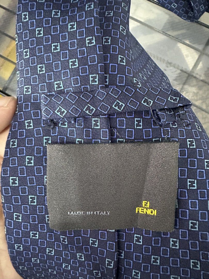 Fendi Silk Tie Navy Blue FF Pattern (Category: Ties) located in Manila. Submitted by declutterpromax (Listing ID 1460197560, Image 3). Description: - Fendi tie - Navy blue color - Classic FF pattern all over - Made in Italy - 100% Silk - Adds a touch of luxury to any outfit.
