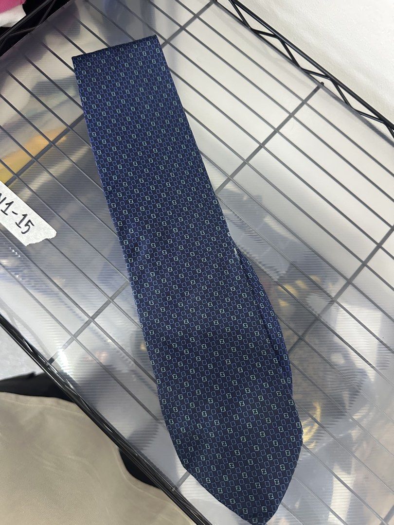 Fendi Silk Tie Navy Blue FF Pattern (Category: Ties) located in Manila. Submitted by declutterpromax (Listing ID 1460197560, Image 1). Description: - Fendi tie - Navy blue color - Classic FF pattern all over - Made in Italy - 100% Silk - Adds a touch of luxury to any outfit.