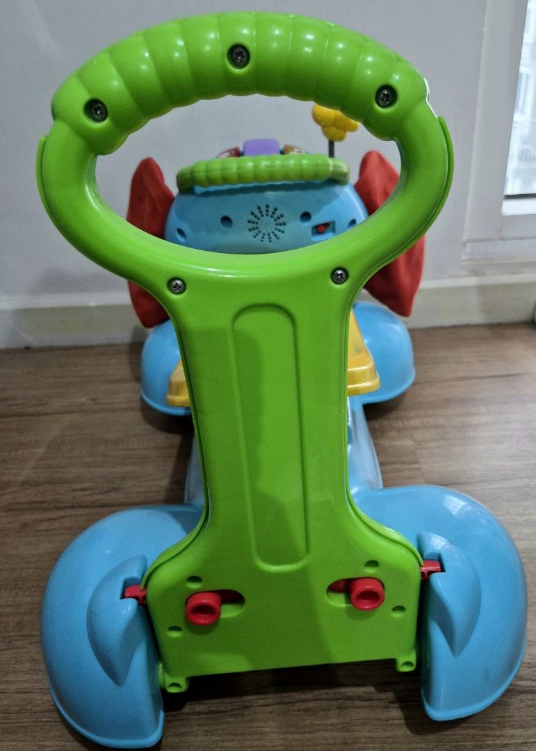 Fisher-Price Elephant Walker Toy (Category: Infant Playtime) located in Makati City. Submitted by mckie (Listing ID 1460128236, Image 3). Description: - Fisher-Price Blue Elephant Walker Toy - Features green handle and yellow seat - Lights and sounds on the front for engagement - Spinning butterfly on top adds fun - Purple wheels - Ideal for babies learning to walk - Shows minor scuffs from normal play, but fully functional.