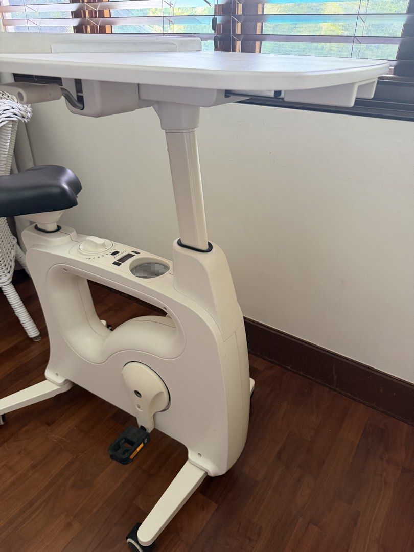 FlexiSpot White Exercise Bike Desk (Category: Cardio & Fitness Machines) located in Muntinlupa City. Submitted by lighterclosets (Listing ID 1460166741, Image 3). Description: - White exercise bike with built-in desk - Stay productive while you exercise - Adjustable desk height - Multiple resistance levels (dial indicator) - Wheels for easy portability - Compact design, ideal for home use.