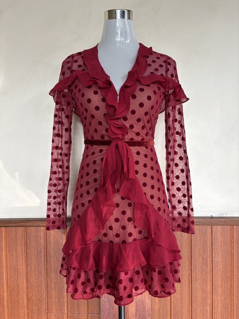 For Love & Lemons Red Dotty Ruffled Mini Dress (Category: Dresses) located in Cebu City. Submitted by stylingtrends.coll (Listing ID 1460110585, Image 2). Description: - Red polka dot dress - Sheer sleeves with polka dots - Ruffle details on neckline and hem - Includes velvet tie belt - Back zipper closure Size: Small.