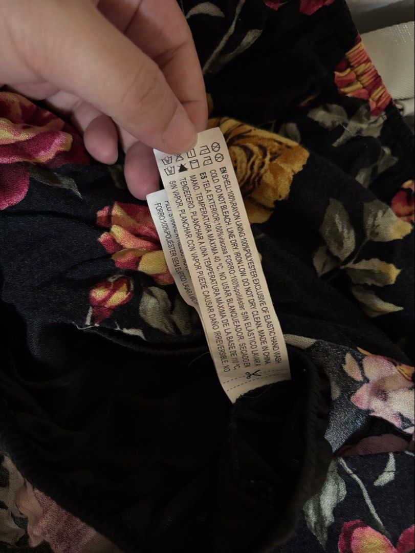 Forever 21 Black Floral Off-Shoulder Top (Category: Blouses) located in Trece Martires City. Submitted by decluttercloset_niks (Listing ID 1460298417, Image 3). Description: - Brand: Forever 21 - Style: Off-shoulder top - Color: Black with vibrant floral print (yellow & pink flowers) - Sleeves: Short with elasticated neckline - Material: Lightweight, ideal for warm weather - Size: L - Origin: Made in China.