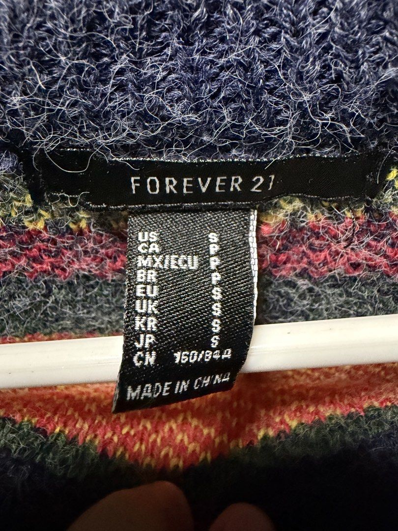 Forever 21 Fair Isle Knit Sweater (Category: Coats, Jackets and Outerwear) located in San Jose del Monte. Submitted by thriftream (Listing ID 1460268712, Image 2). Description: - Cozy knit sweater from Forever 21 - Features a colorful fair isle pattern on a navy blue base - Crew neck and long sleeves - Ideal for cooler weather - Approximately 19 inches in length and 21 inches wide.