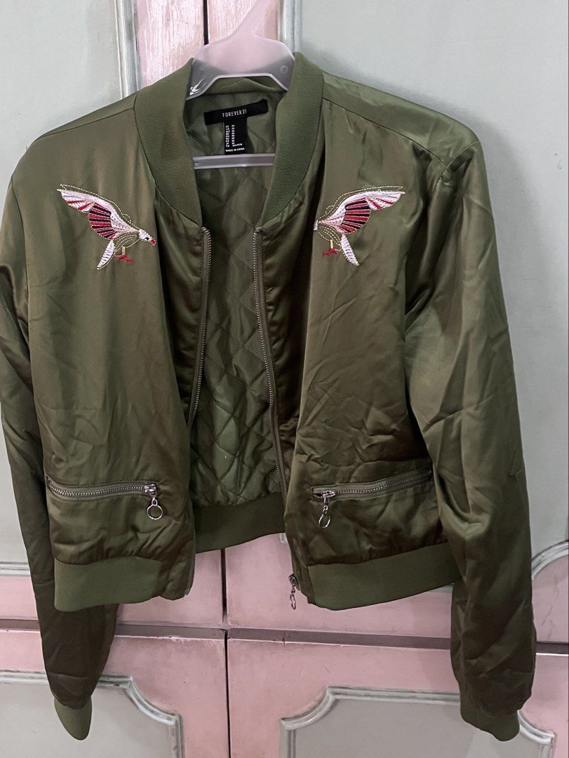 Forever 21 Green Bomber Jacket with Eagle Embroidery (Category: Coats, Jackets and Outerwear) located in Quezon City. Submitted by jreesey (Listing ID 1460127719, Image 1). Description: Forever 21 Green Bomber Jacket - Design has red, black, and white embroidered birds/eagles - Back includes statement graphic, says“Join a Girl Gang” - 2016-2018 vibes - Shiny olive green or army green color - Cropped style RFS: Decluttering Payment Method Options: