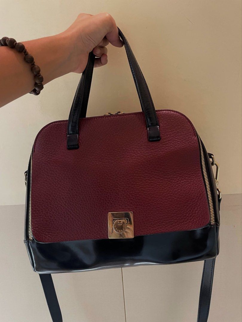 Furla Divina 2-Way Leather Handbag (Category: Luxury Bags & Wallets) located in Manila. Submitted by thevintagebow (Listing ID 1460188073, Image 1). Description: Elevate your everyday style with this authentic Furla Divina 2-way handbag 🍷 This striking piece features a rich burgundy pebbled leather paired with a sleek glossy black patent base, accented by polished gold-tone hardware. Beautifully versatile—wear it by the top handles for a polishe