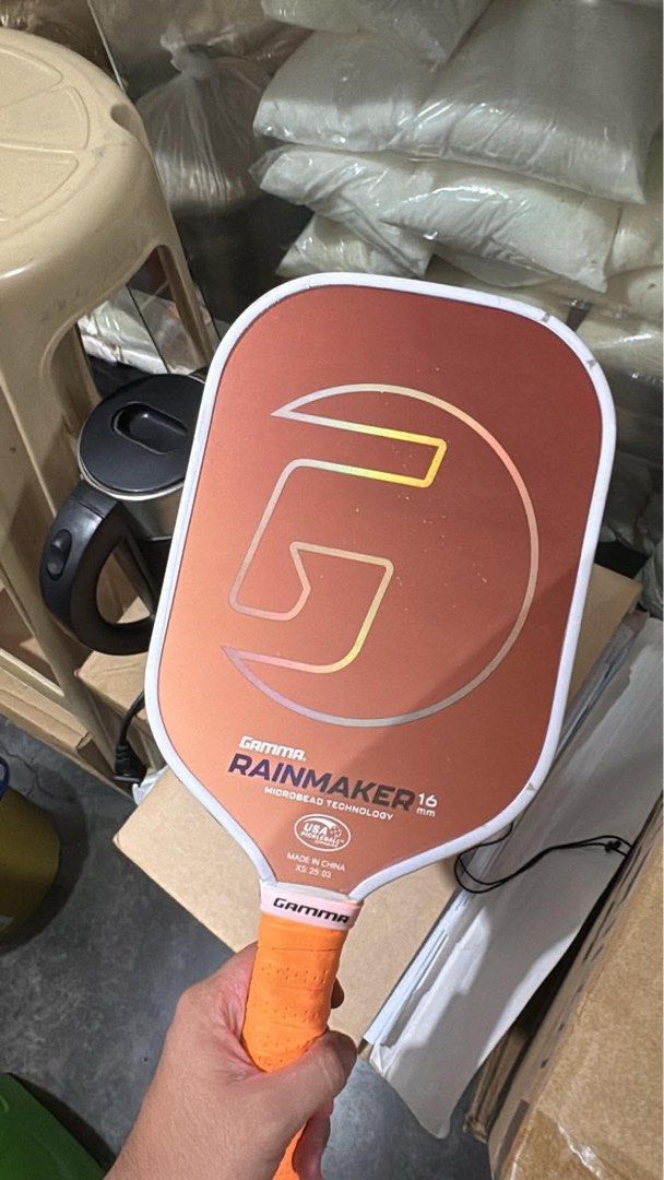 GAMMA Rainmaker 16mm Pickleball Paddle (Category: Racket and Ball Sports) located in Manila. Submitted by phennilo (Listing ID 1460226185, Image 3). Description: - GAMMA Rainmaker Pickleball Paddle - Striking Orange/Bronze color - 16mm thickness for optimal control - Features advanced Microbead Technology Perfect for Beginners to Intermediate .