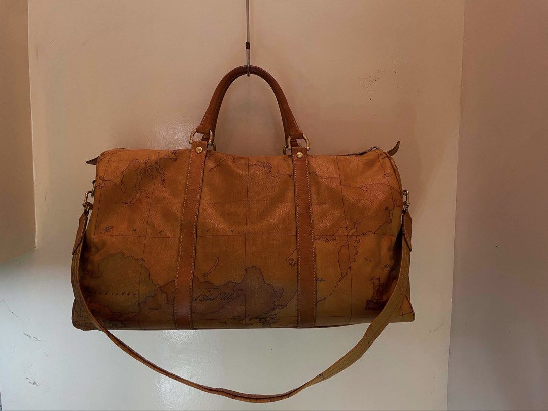 Geo Classic Travel Bag (Category: Luxury Bags & Wallets) located in Manila. Submitted by thevintagebow (Listing ID 1460204568, Image 1). Description: Pack your bags with the Alviero Martini 1ᴬ Classe Geo Classic Duffel 📍 Travel in iconic style with this signature world-map print weekender, featuring rich dark-tan leather trim, double top handles, and an optional shoulder strap. 🛩️ Comparison of Prices: Original Retail: ₱25,000+ php ($450+ USD) 
