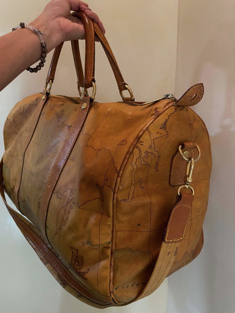 Geo Classic Travel Bag (Category: Luxury Bags & Wallets) located in Manila. Submitted by thevintagebow (Listing ID 1460204568, Image 2). Description: Pack your bags with the Alviero Martini 1ᴬ Classe Geo Classic Duffel 📍 Travel in iconic style with this signature world-map print weekender, featuring rich dark-tan leather trim, double top handles, and an optional shoulder strap. 🛩️ Comparison of Prices: Original Retail: ₱25,000+ php ($450+ USD) 