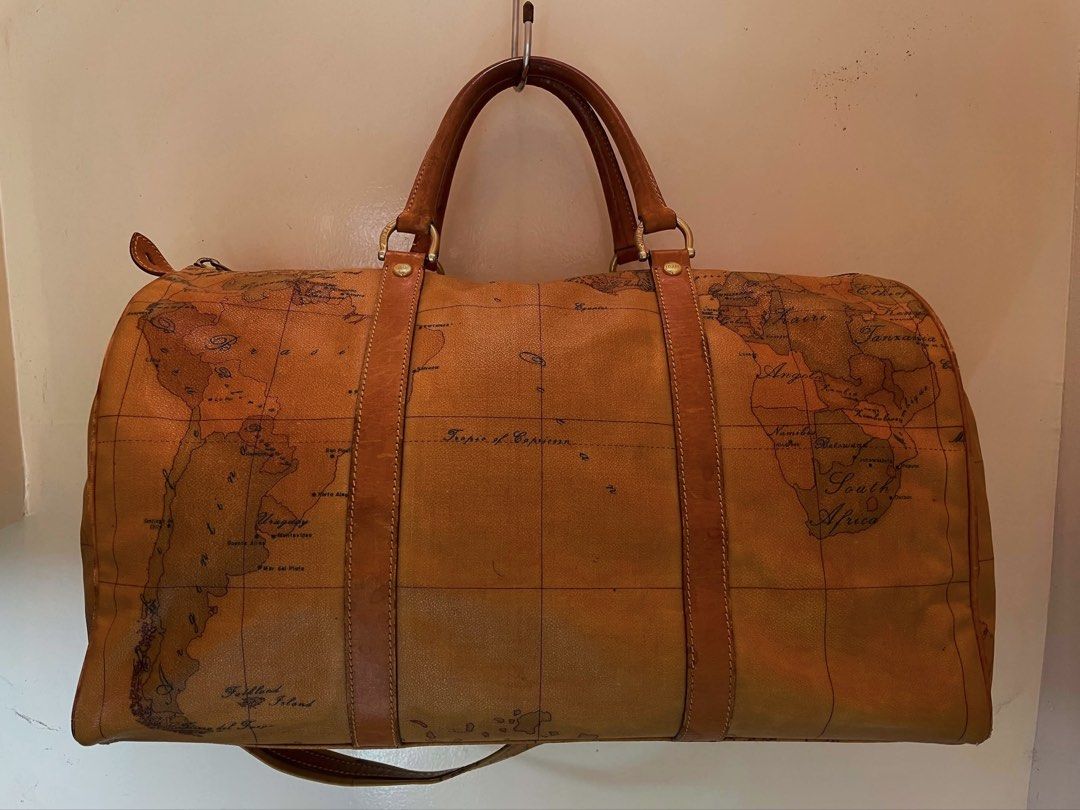 Geo Classic Travel Bag (Category: Luxury Bags & Wallets) located in Manila. Submitted by thevintagebow (Listing ID 1460204568, Image 3). Description: Pack your bags with the Alviero Martini 1ᴬ Classe Geo Classic Duffel 📍 Travel in iconic style with this signature world-map print weekender, featuring rich dark-tan leather trim, double top handles, and an optional shoulder strap. 🛩️ Comparison of Prices: Original Retail: ₱25,000+ php ($450+ USD) 