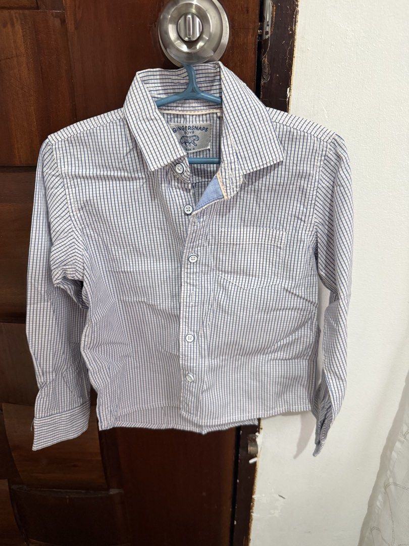 Gingersnaps Boys Shirt Size 4 (Category: Babies & Kids Fashion) located in Bacoor. Submitted by annemargarett (Listing ID 1460155650, Image 1). Description: - Brand: Gingersnaps - Style: Boys shirt - Pattern: Blue and white checkered - Sleeves: Long sleeves with button cuffs - Features: Chest pocket on the left - Occasion: Great for casual wear or dressing up.