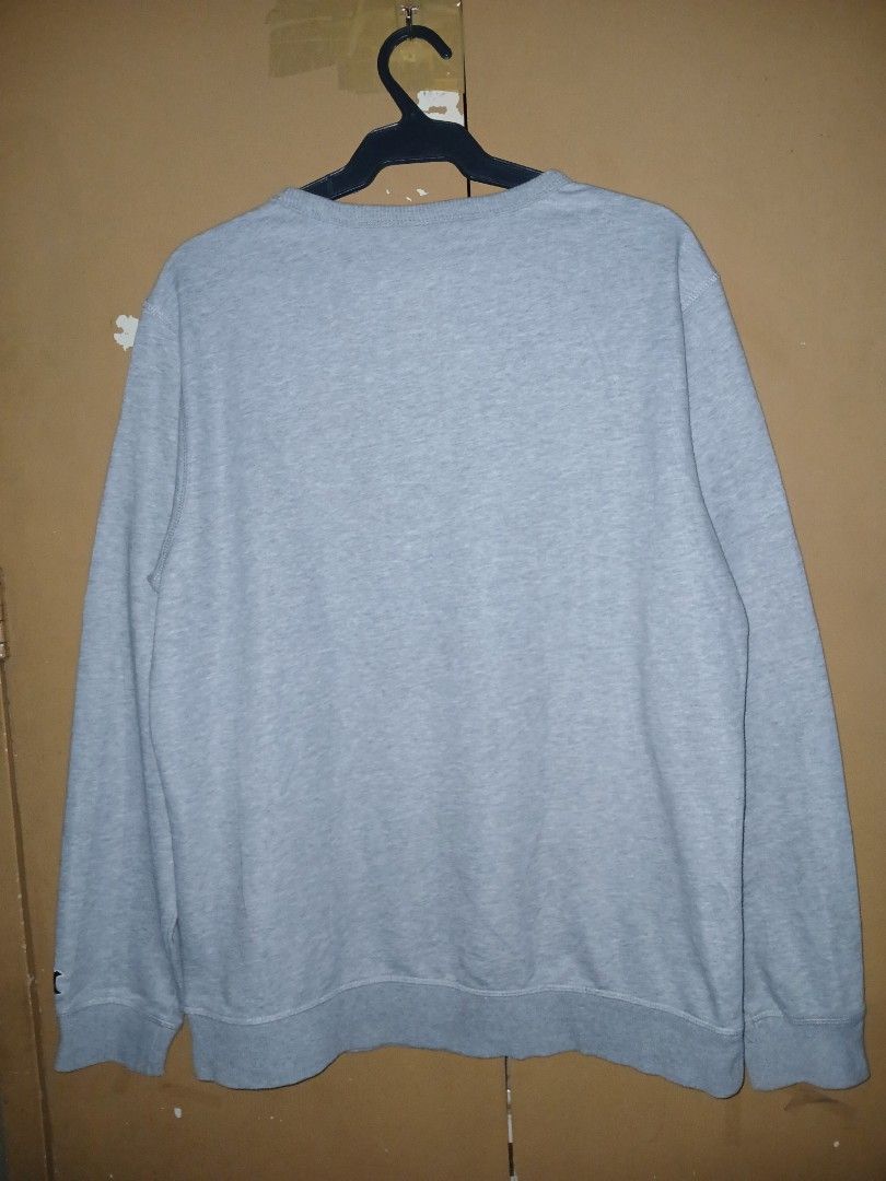 Gray crewneck sweatshirt (Category: Coats, Jackets and Outerwear) located in Quezon City. Submitted by dealmaker8 (Listing ID 1460183343, Image 2). Description: gray crewneck sweatshirt featuring a vibrant, multi-colored patterned Alan Walker logo on the front width 22 length 27.