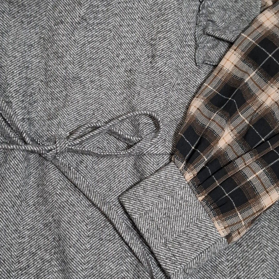 Grey Ruffle Mock Neck Plaid Sleeve Top (Category: Blouses) located in Pasig City. Submitted by m_r_g (Listing ID 1460237492, Image 2). Description: - Fits medium to semi large - Cozy grey top with a stylish mock neck - Features charming ruffle details down the front - Contrasting plaid sleeves add a unique touch - Adjustable drawstring waist for a perfect fit - Versatile for layering or wearing as a standalone piece.