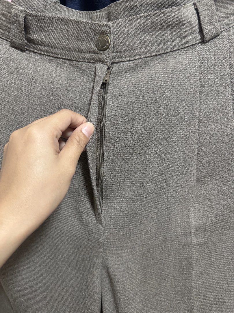 Grey Trousers with Button and Zip Closure (Category: Other Bottoms) located in Quezon City. Submitted by euniceescalada9 (Listing ID 1460126453, Image 3). Description: - Classic grey trousers - Button and zip closure - Belt loops for added style - Front pleats for a tailored fit - Subtle textured fabric - Versatile for work or casual occasions - Can fit 26 waistline , length is 35.