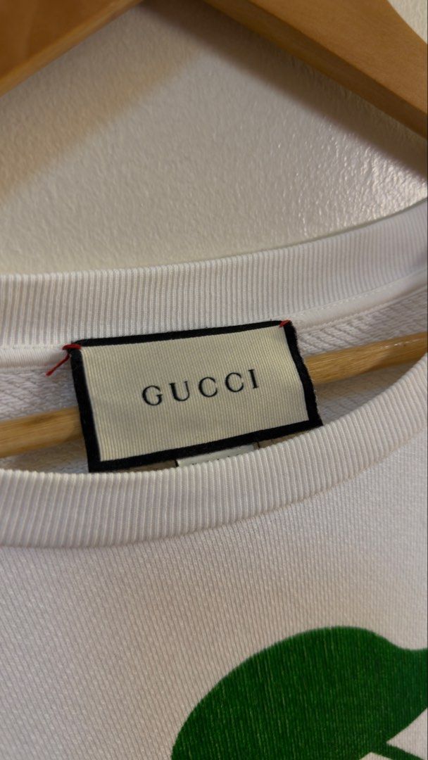 Gucci Beverly Hills Cherry Sweatshirt White (Category: Coats, Jackets and Outerwear) located in Paranaque City. Submitted by mykapoynton (Listing ID 1460293553, Image 3). Description: Gucci Beverly Hills Cherry Sweatshirt White - Iconic Cherry Print - Features 'Gucci Beverly Hills!' Text - Made in Italy - Size: Tagged XS (160/84Y) - Design: Crew neck, long sleeves - Style: Casual and stylish.
