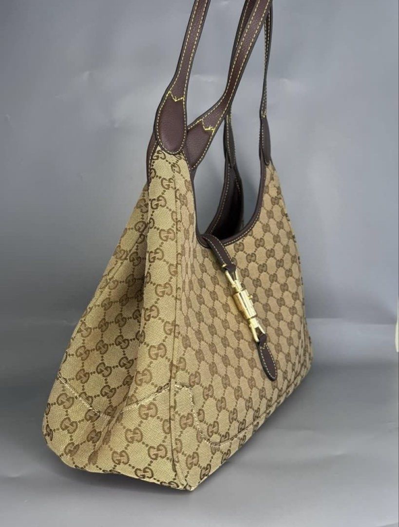 Gucci Monogram Canvas Hobo Bag (Category: Luxury Bags & Wallets) located in Manila. Submitted by cheapful (Listing ID 1460224413, Image 3). Description: - Classic Gucci hobo bag - Beige GG monogram canvas - Dark brown leather trim - Gold-tone hardware with signature Gucci clasp - Comfortable shoulder strap - Spacious interior, great for everyday use - Timeless and iconic piece.