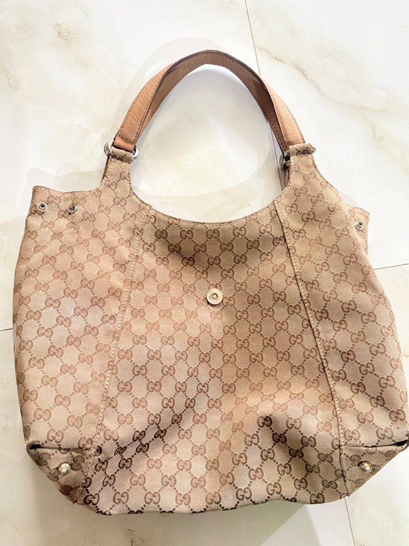 Gucci Monogram Canvas Hobo Shoulder Bag (Category: Luxury Bags & Wallets) located in Caloocan City. Submitted by fierce_mica29 (Listing ID 1460235883, Image 1). Description: - Gucci hobo bag - Beige GG monogram canvas with tan leather trim and straps - Interior: 1 zip pocket, 2 slip pockets - Signs of wear on interior lining and leather - Classic and timeless Gucci design.