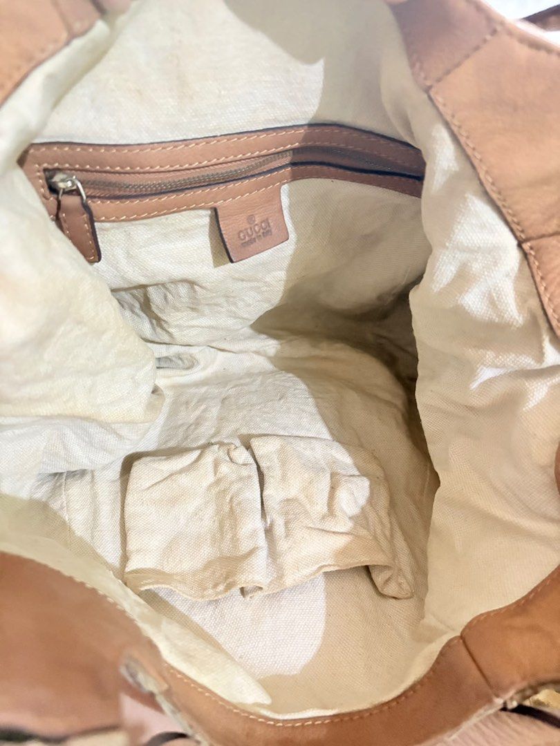 Gucci Monogram Canvas Hobo Shoulder Bag (Category: Luxury Bags & Wallets) located in Caloocan City. Submitted by fierce_mica29 (Listing ID 1460235883, Image 2). Description: - Gucci hobo bag - Beige GG monogram canvas with tan leather trim and straps - Interior: 1 zip pocket, 2 slip pockets - Signs of wear on interior lining and leather - Classic and timeless Gucci design.